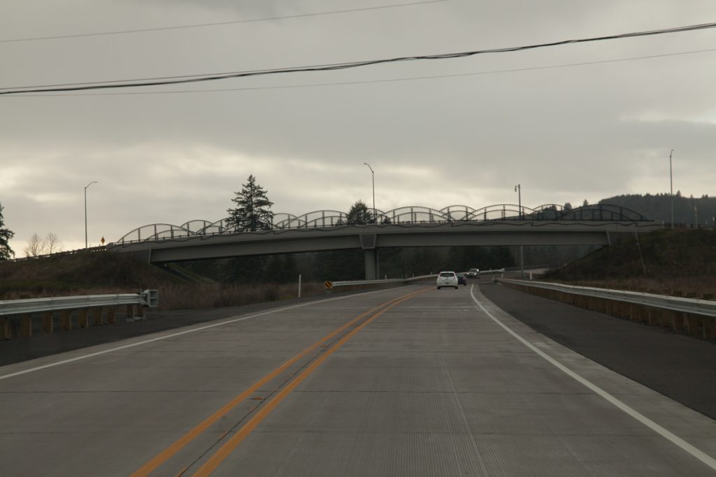 Nearing the SE Parks Dr. overpass, also known as the "Fulquartz Loading Road". A police turnout is on the left. As with the 8th St. overpass, right-of-way has been set aside for future widening to 4 lanes. Compare to how it looked in September.