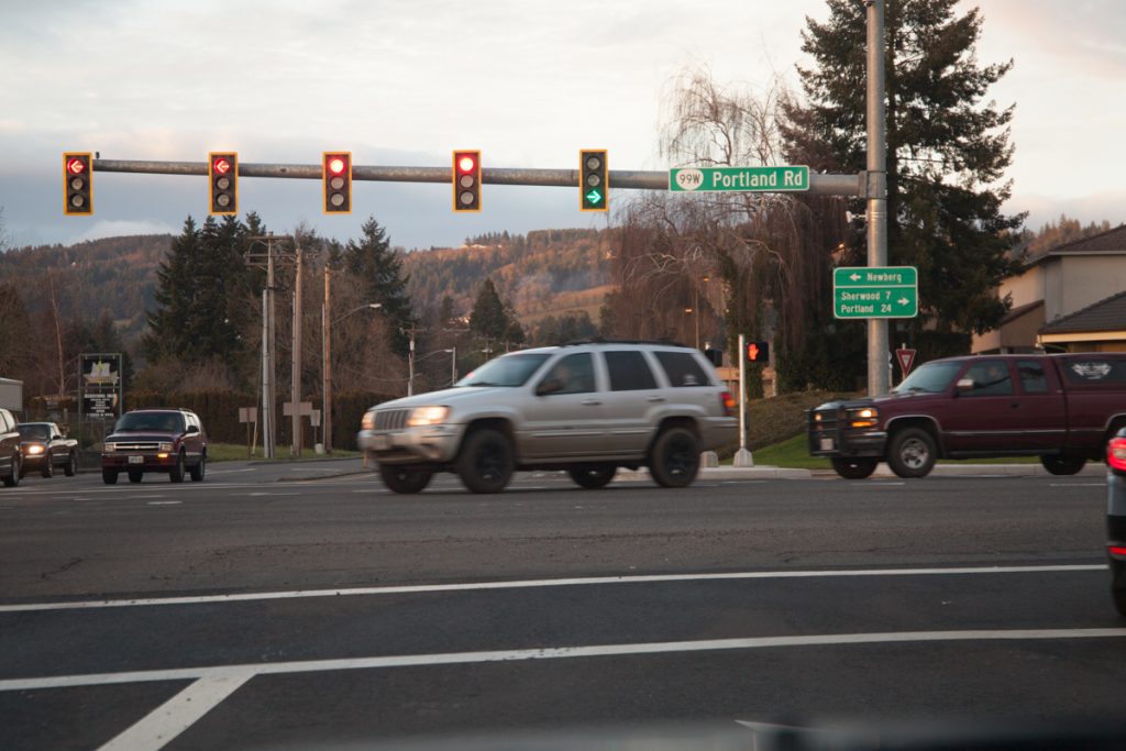 Northbound traffic gets its own right turn arrow phase at this traffic light. The two signs in this photo are new.
